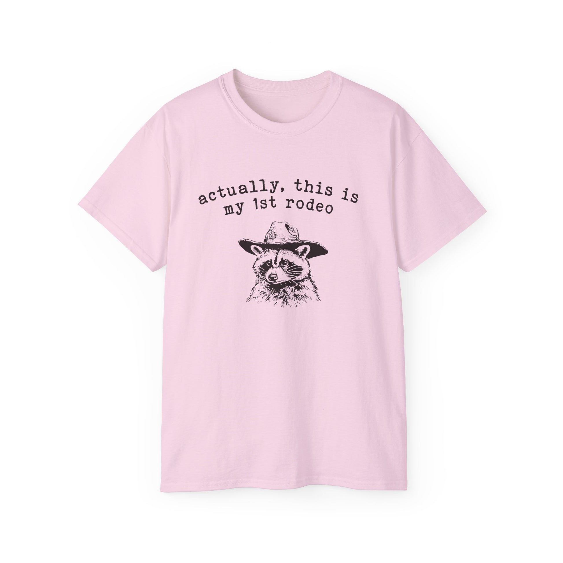 A pink t-shirt with a raccoon printed on it